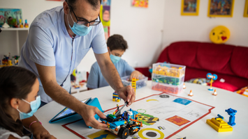 Teacher using alternative teaching methods to work with their students